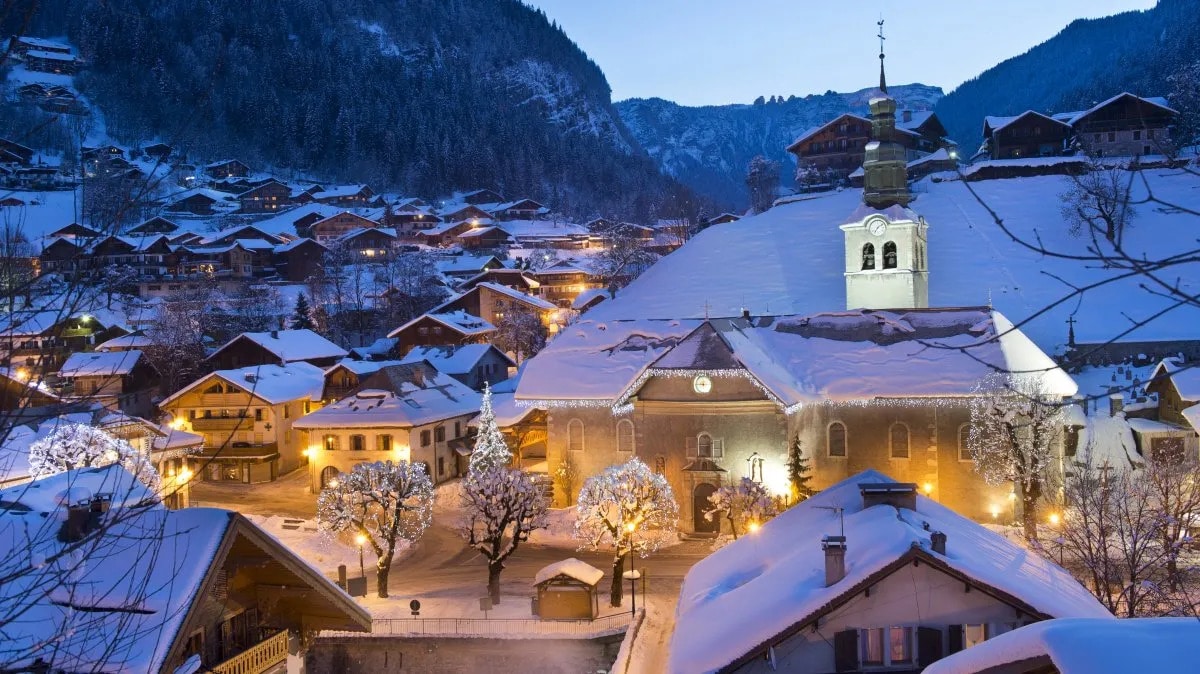 Morzine village centre and church at night in the snow